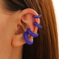 Close-up of four royal blue rhinestone C-shaped ear cuffs on a female model - Model 6397 / Set of 4 / Dark Blue