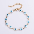 Golden Evil Eye bracelet with twelve blue enamel beads and adjustable lobster clasp - White