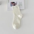 Chic pointelle knit crew socks in creamy white featuring delicate hollow-out patterns - One Size / Cream