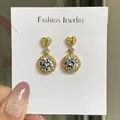 Gold plated heart and round cubic zirconia drop earrings displayed on a jewelry card - Golden Heart-shaped Earrings Led-120