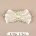 Light green silk sleep mask featuring a decorative oversized cream bow design - Luxury Green