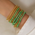Bohemian multilayer seed bead bracelet in gold and green tones worn by model - Yellow Green Transparent Style (0036)