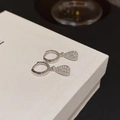 Detail of silver water-drop earrings with pavé-set zircons on a white gift box - Silver Huggie Teardrop Pave Style (A10 Silver)