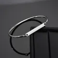 Polished silver stainless steel open bangle featuring a customizable rectangular metal plate - Steel