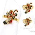 Detailed view of a gold Christmas stocking napkin ring with festive red and green rhinestones - Christmas Stocking (10)