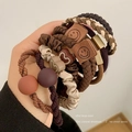 Variety pack of earthy tone elastic hair ties with leather smiley face and heart charms - Mixed Style D