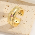 Macro shot of gold wide band ring featuring pink heart gemstone and clear round stones - Pink Heart Zirconia Style (Pink Zircon)