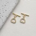 Detailed macro view of 14K gold plated heart OT toggles with micro-set zircon accents - Style E Heart Zirconia / 14K Gold
