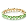 Detail shot of heart-cut green zircon stones set in a gold-plated link bracelet - Green