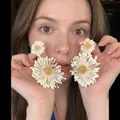 Close-up of oversized white daisy earrings featuring yellow centers on female model - Gold/Light Pink (8# Silver Needle)