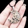 Handheld moon-shaped dalmatian jasper pendant with a black woven cord necklace - 30mm Dalmatian Stone
