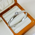 Silver water drop zircon bangle with polished finish and secure clasp on velvet cushion - 6mm Water Drop Zirconia Style / Steel