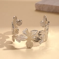 Detail shot of silver pleated floral cuff with intricate hollow flower petal textures - Silver Flower