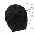 Detailed view of black textured baby turban hat with a large decorative bow - Black