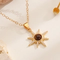 Detail of gold starburst necklace featuring brown gemstone and zircon inlay on stone - Radiating Starburst Style (3165)