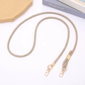 Close-up of golden braided phone strap with metallic clasps on a clean white desk - Adjustable Crossbody / Khaki