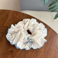 Detailed macro of floral print scrunchie with blue edging and decorative button - Floral Blue Edge - Bowknot Button Flower Scrunchie