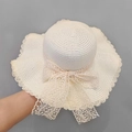 Straw sun hat in cream white featuring wide lace bow and wavy brim for summer beach style - Off-white Lace Bow