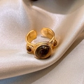 Vintage gold open ring with three tiger eye stones on silver silk background - Gold Brown