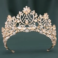 Detailed close-up of golden Baroque crown with champagne crystals and floral metal patterns - KC Gold White & Champagne Crystal