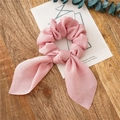 Pink satin ribbon scrunchie with long bow tie design on a wooden background - Light Pink