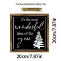 Detail of wooden Christmas sign featuring white tree print and sawtooth wall hanger - Black Christmas Tree