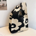 Detailed knit texture of a floral woven tote bag with black and beige flower patterns - Black-Flower