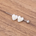DIY shell heart bead with gold letter N on wooden background for jewelry making - Letter N