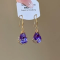 Detailed view of handmade resin drop earrings with embedded purple dried flowers - Style 3 (HE31316) / Blue