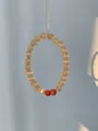 Detail showing natural brown cat-eye agate beads on a vertical silver chain - Yellow Cat's Eye & Pink Sunstone & Pearl Bracelet