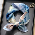 Knotted blue floral silk scarf displayed on a black tray with elegant book background - Dreamy Hydrangea
