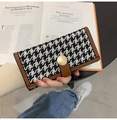 Detail showing the brown leather trim and houndstooth texture on a long wallet with gold buckle - Long Coffee