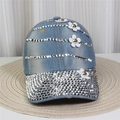 Detailed close-up of light blue denim baseball cap with sparkling rhinestones and white floral 3D decor - Style 39-Light Blue Denim Rhinestone Flower