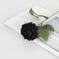 Artificial black velvet rose with green stem placed on an open vintage book page - Small Velvet Black