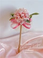 Detail of pink hydrangea flower pen with silk bow and pearl on satin fabric - Pink