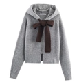 Detail of grey hooded knit cardigan featuring a large dark brown bow and zip front - S / Space Gray
