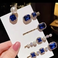 Close-up of vintage blue rhinestone hair clips set with pearls on gold-tone base - Royal Blue Gold 5-Piece Set