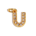 Detailed view of a gold letter U pendant with sparkling zircons and a polished bail - Letter U / Gold