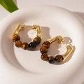 Detailed view of C-shaped golden earrings featuring brown tiger eye beads in a stone tray - Coffee Tiger Eye Beaded (Silver Pin)
