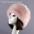 Close-up of light pink faux fur hat for winter with fluffy texture on display stand - Pink Medium Fur