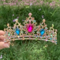 Detail of a baroque bridal crown with colorful rhinestones and gold metal finish - Gold + Multicolor Gemstones