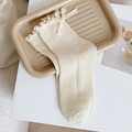 Creamy white mid-calf socks with delicate ruffle trim and cute ribbon bow detailing - One Size / Beige