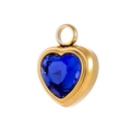 Detailed macro view of a heart-shaped golden pendant with a deep blue faceted crystal - Deep Blue Gemstone Heart Pendant