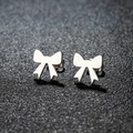 Polished stainless steel bow stud earrings presented on a dark textured background - 105 Bow / Steel