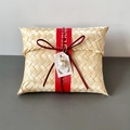 Detail of handmade bamboo gift box with red silk ribbon and elegant pearl pendant charm - Flat Box Red Cord Style