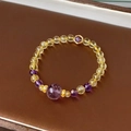 Macro shot of purple amethyst and yellow citrine beads with gold flower spacers on leather - Citrine Amethyst Beaded Bracelet