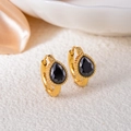 Detailed close-up of vintage gold-plated earrings with black teardrop gemstone settings - Water Drop Zirconia / Black