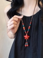 Ethnic beaded necklace featuring red star pendant and green accents on a brown rope - Red Star Ethnic Style