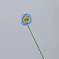 Handmade crochet small flower in sky blue and orange on a minimalist grey background - Light Blue Poppy