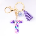 Detail of letter T crystal resin keychain with colorful stones and a purple tassel - Letter T